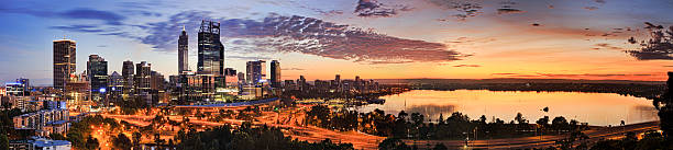 PERTH CBD Kings Orange Rise Wide panorama of Perth city CBD as seen from Kings Park lookout at sunrise. Rising orange sun reflects in still waters of Swan river and lights towers of city centre. kings park stock pictures, royalty-free photos & images