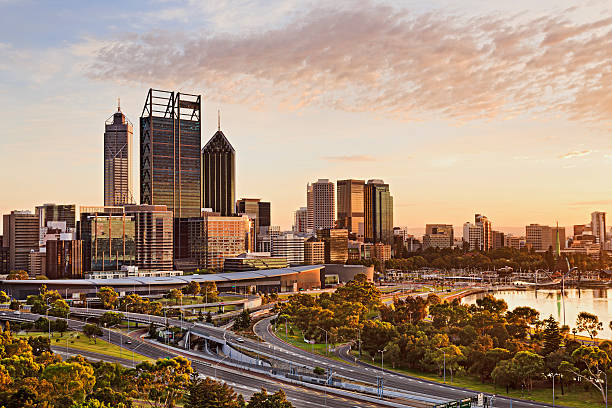 PRTH CBD gold rise close Westerna Australia capital city Perth at sunrise during golden hour. Bright warm sun light sheds on skyscrapers and city-line. perth australia photos stock pictures, royalty-free photos & images