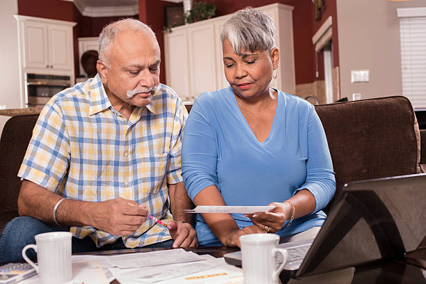 istock Senior couple paying monthly bills at home. 598787658