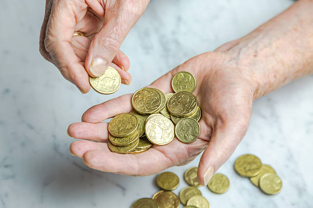 close-up of senior female hands counting dollar coins - australian dollars australia australian culture finance imagens e fotografias de stock