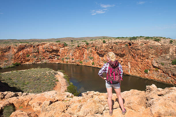 Woman Outback Yardie Creek Exmouth Australia Blonde woman hiking in outback Australia, overlooking Yardie Creek river in Cape Range National Park, Exmouth, summer sunny blue sky, copy space. cape range national park photos stock pictures, royalty-free photos & images