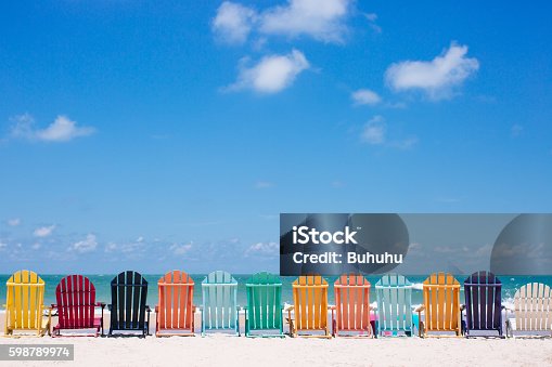 istock Beautiful color chairs on the beach 598789974