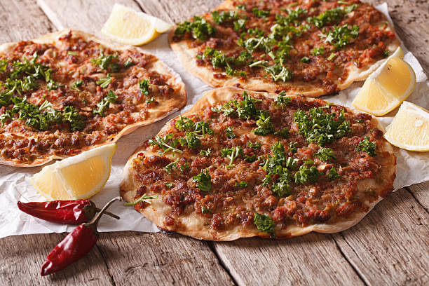 istock Turkish lahmacun closeup on a wooden table. Horizontal 598792644