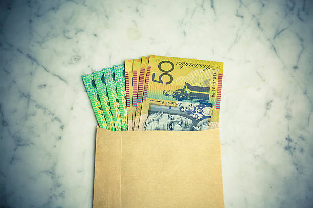 bribery and corruption: cash in brown paper envelop - australian dollars australia australian culture finance imagens e fotografias de stock