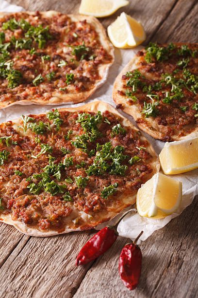istock Turkish lahmacun closeup on a wooden table. vertical 598792814