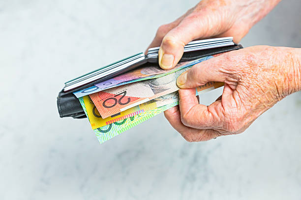istock Payment: Close-up senior female hands taking banknotes from purse 598793916