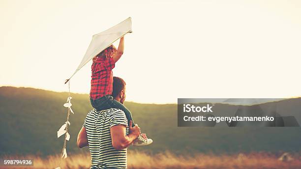 Happy Family Father And Child On Meadow With A Kite Stock Photo - Download Image Now