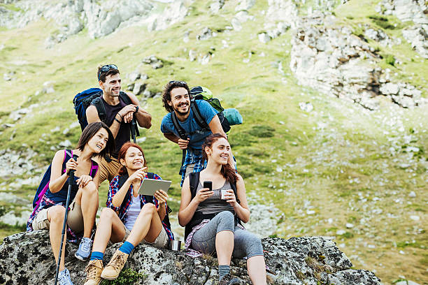 istock Group of hikers with tablet resting on a rock 598796328