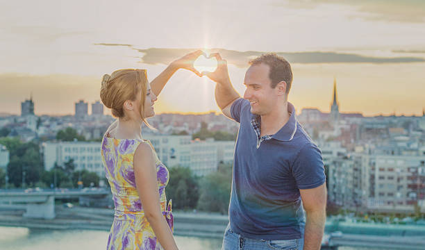 istock Love is magic. Romantic couple making hart on Sunset sky. 598798736