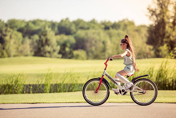 istock Girl riding bike 598801328