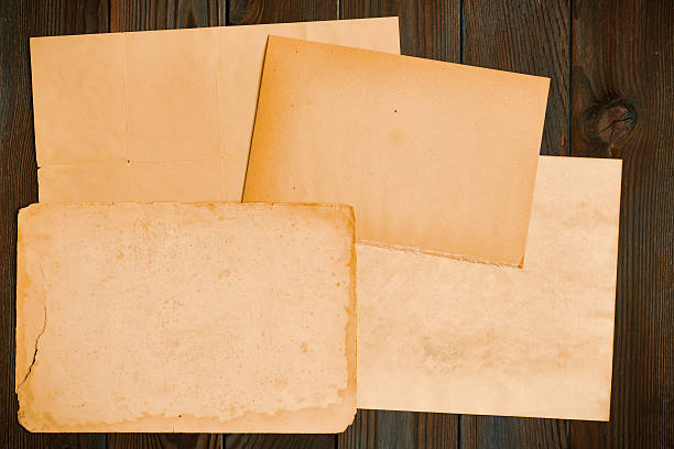istock Vintage paper on textured old wooden background 598802320