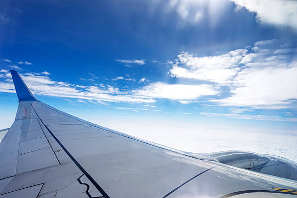 Clouds and sky as seen through window of an aircraft