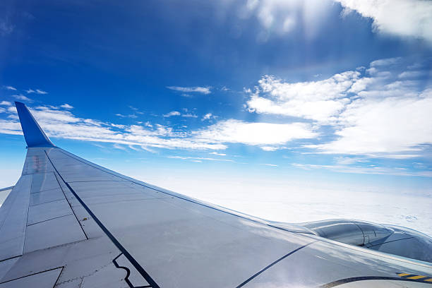 Clouds and sky as seen through window of an aircraft stock photo