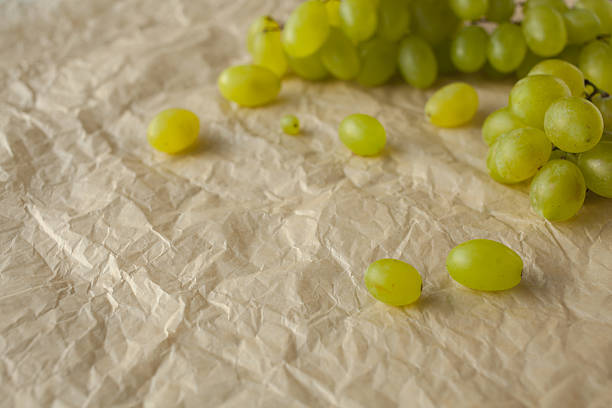 Bunch of green grapes on paper background