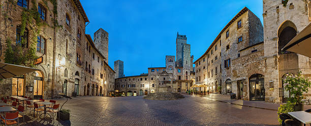 Piazza della Cisterna Panoramic view of famous Piazza della Cisterna in the historic town of San Gimignano on a morning, Tuscany, Italy. siena italy stock pictures, royalty-free photos & images