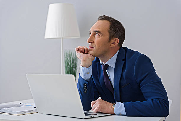 istock Adult businessman working in office 598809774