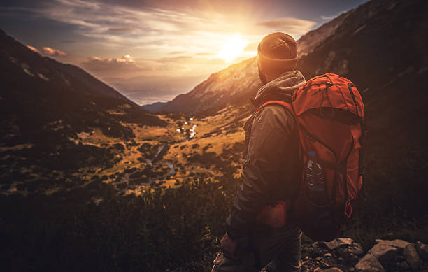 istock Traveler watching the sunset over the mountains 598812248