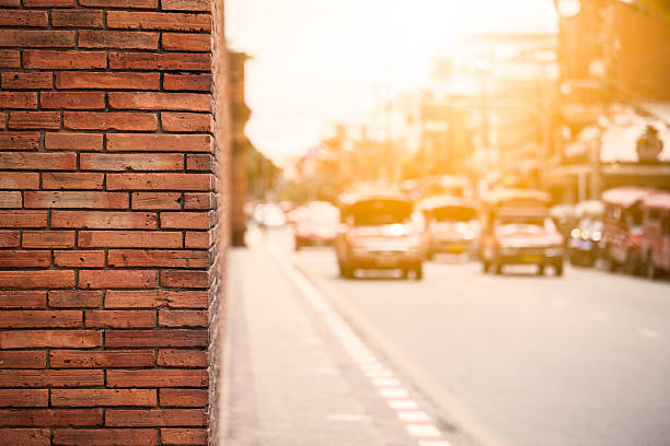 istock Orange brick wall with traffic in sunset, Chiang Mai Thailand 598812346