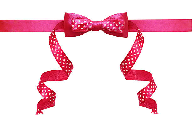 Pink silk polka dot ribbon bow isolated on white