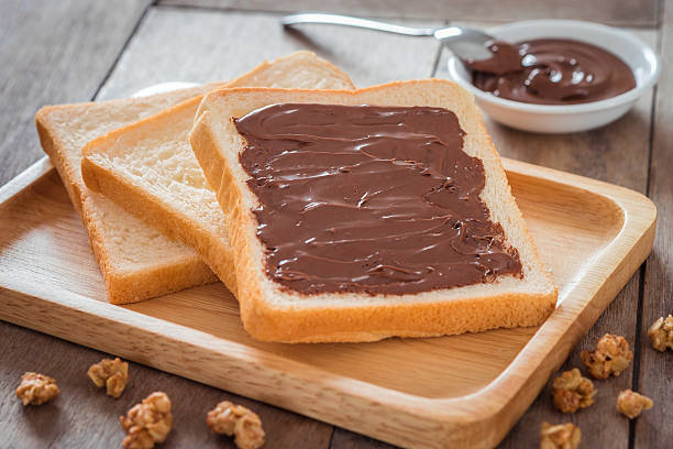 istock Bread with chocolate cream on wooden plate 598819330