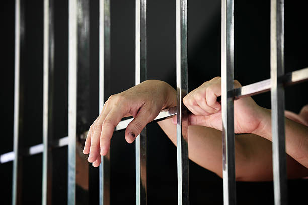istock hand of prisoner in jail 598819646