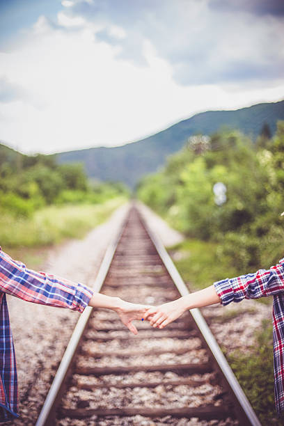 istock Couple walking on railroad 598822844