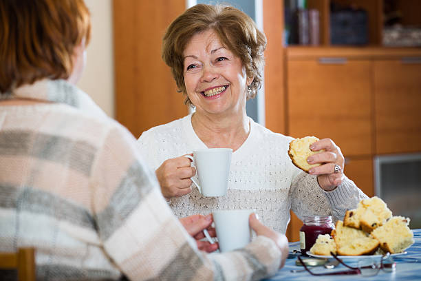 istock Positive female pensioners drinking coffee and chatting 598824260