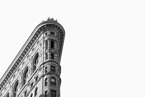 Black and white image of the high section of the Flatiron building in New York City.