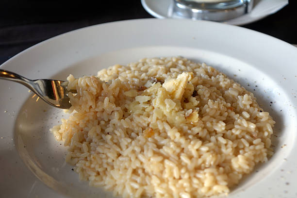 Risotto with cheese sauce and parmesan on a white bowl