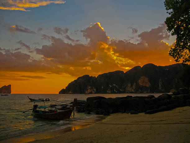 istock Small boat at the Andaman Sea in sunset 598830490