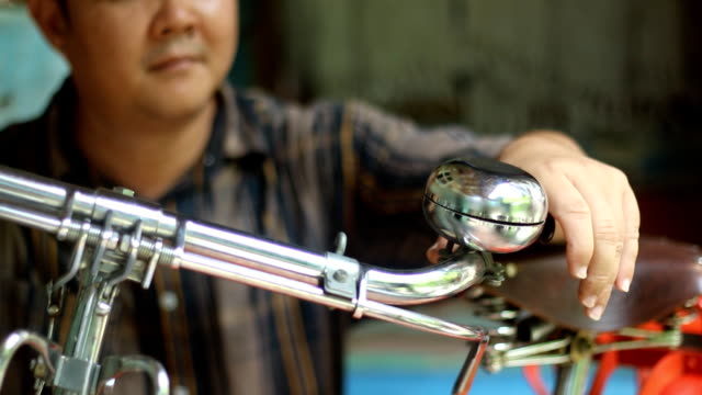 man repair bicycle bell