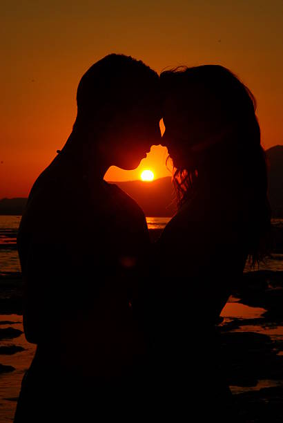 istock young couple in love on the beach, sunset, 598915162