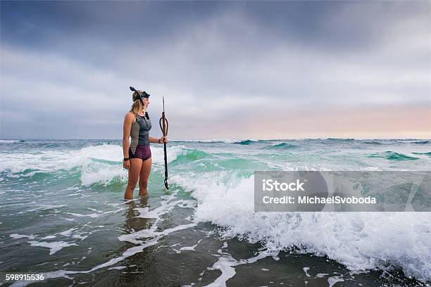 Spearfishing Women Standing In The Ocean Stock Photo - Download Image Now - Adult, Anticipation, Beach