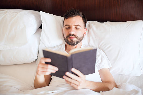 istock Latin man reading a book in the morning 598916472