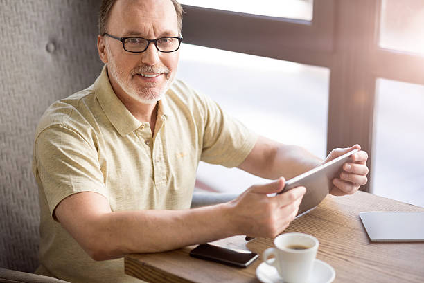 istock Cheerful man sitting at the table 598921184