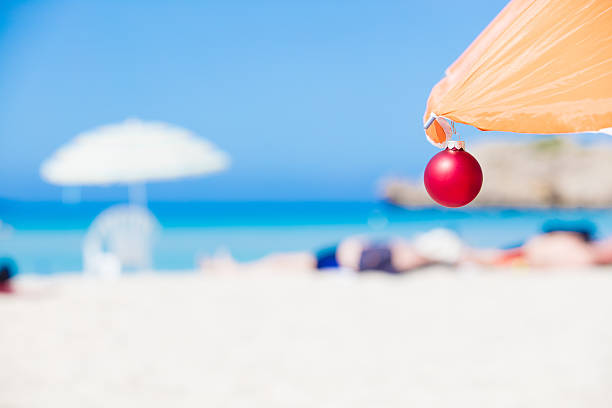 Christmas bauble hanging on parasol at tropical beach. XXXL size image. Image taken with Canon EOS 5Ds and EF 70-200mm USM L 2,8. 