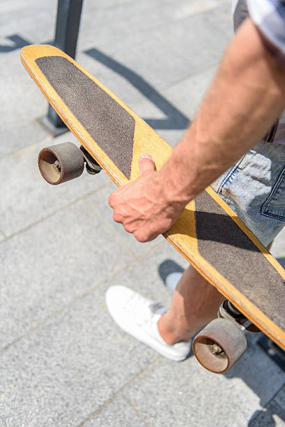 istock Young man holding skate on staircase 598924880