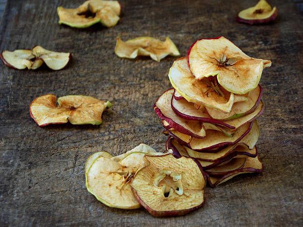 istock dried apples in the wooden background. 598926082