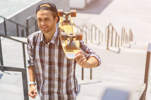 istock Cheerful male skater walking on staircase 598926192