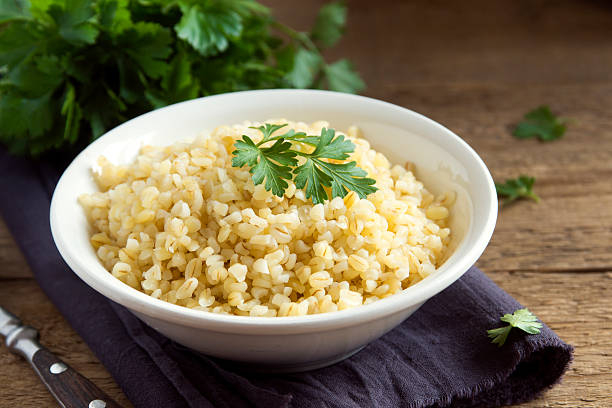 bulgur Organic bulgur wheat grain in white bowl close up, healthy vegetarian food bulgur wheat stock pictures, royalty-free photos & images