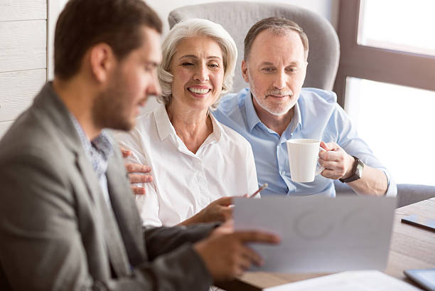 istock Cheerful couple talking with sales manager 598928174