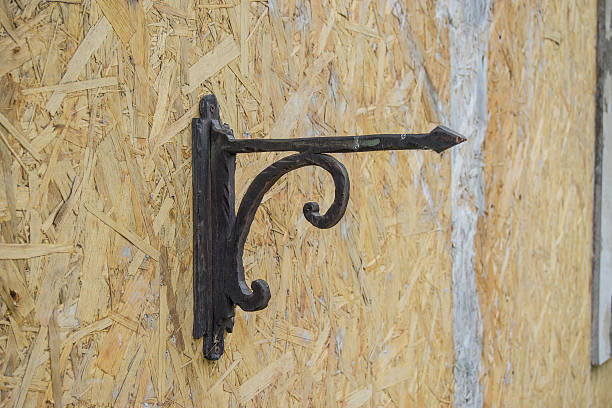 istock The hook on the wooden wall, cast-iron arrow hanging on chipboard 598928556
