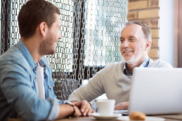 istock Cheerful man talking with his grandson 598931076
