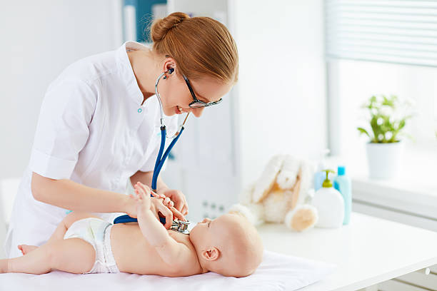 Doctor pediatrician and baby patient Doctor pediatrician and baby patient in clinic pediatrician stock pictures, royalty-free photos & images