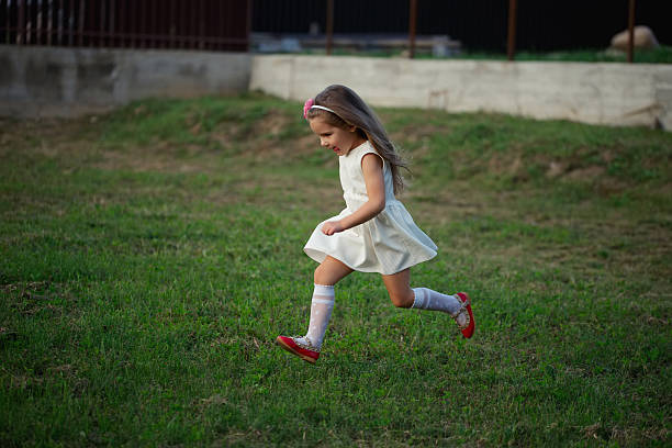 istock little beautiful running girl outside 598937172