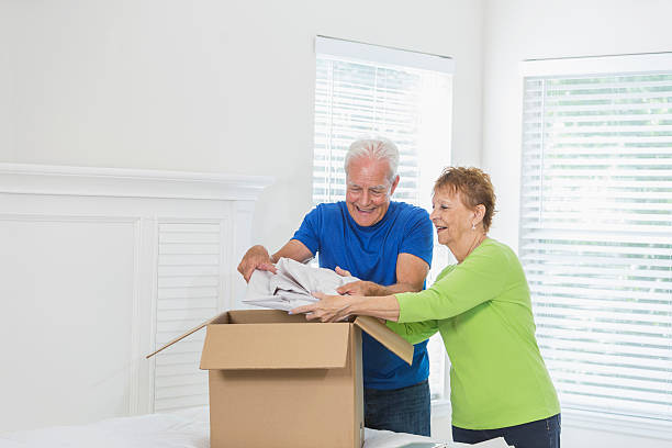istock Senior couple moving house, packing box 598948850