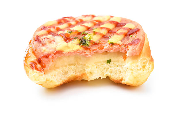 bread with BBQ pork on top with bites on a white background