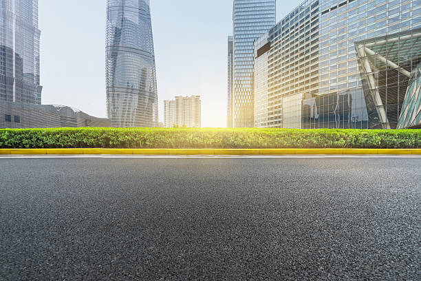 istock clean asphalt road with city skyline background 598950402