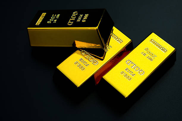 istock three pieces of gold bar on a black background 598950704