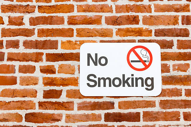 No Smoking Sign On a Red Brick Wall stock photo